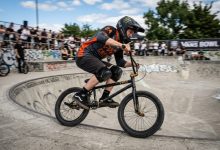 Rider wearing skate shoes correctly positioned on wide BMX platform pedals.