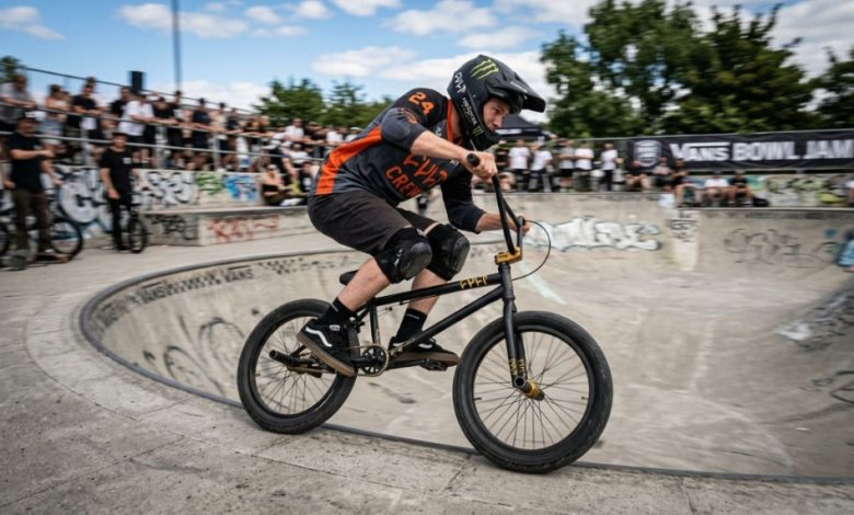 Rider wearing skate shoes correctly positioned on wide BMX platform pedals.