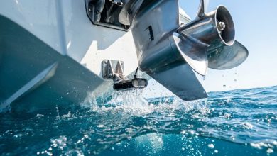 Transducer mounted on a boat transom for a fish finder tracking underwater depths.