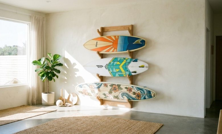 Three surfboards stand safely upright in a wooden indoor storage rack.