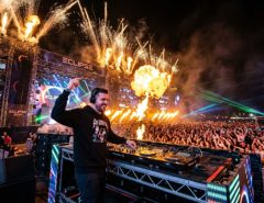 Crowd dancing under stage lights at an Orlando EDM festival