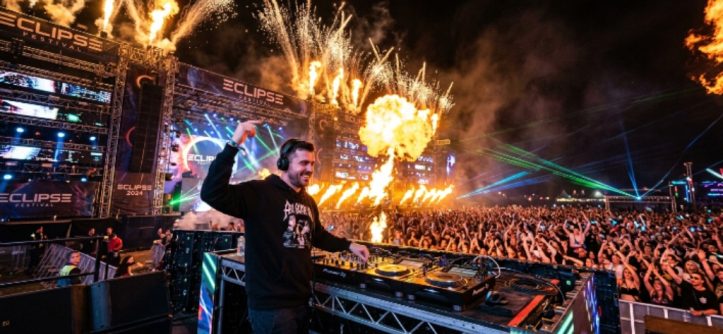 Crowd dancing under stage lights at an Orlando EDM festival