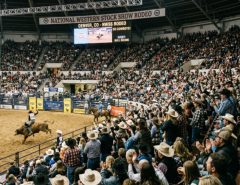 Crowds filling the arena stands during the National Western Stock Show rodeo event in Denver, Colorado