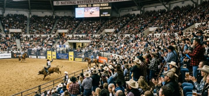Crowds filling the arena stands during the National Western Stock Show rodeo event in Denver, Colorado