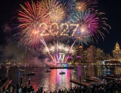 Colorful midnight fireworks exploding over Boston Harbor during First Night Boston 2027 on New Year's Eve