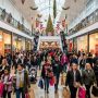 Shoppers walking through a decorated mall corridor on Black Friday morning